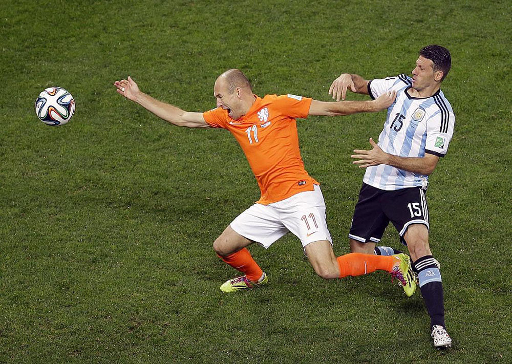 Netherlands' Arjen Robben, is fouled by Argentina's Martin Demichelis during the World Cup semifinal soccer match between the Netherlands and Argentina at the Itaquerao Stadium in Sao Paulo Brazil, Wednesday, July 9, 2014.