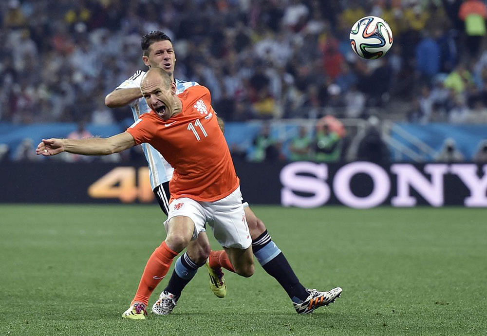 Netherlands' Arjen Robben (11) is fouled by Argentina's Martin Demichelis during the World Cup semifinal soccer match between the Netherlands and Argentina at the Itaquerao Stadium in Sao Paulo Brazil, Wednesday, July 9, 2014.