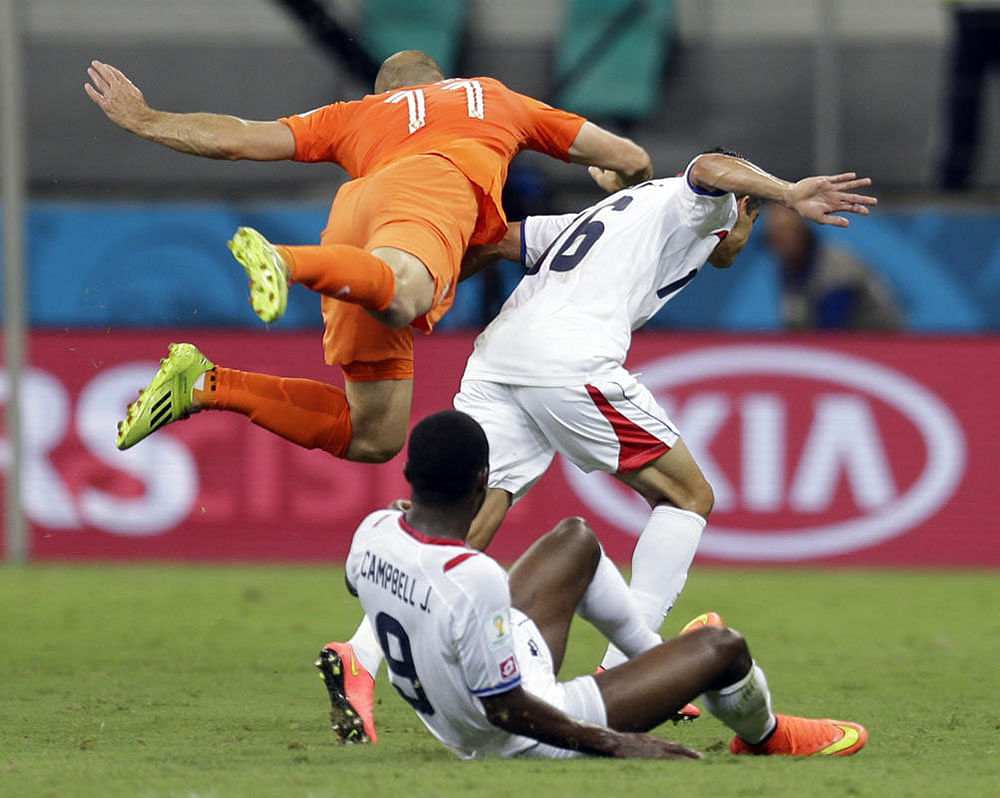 Netherlands' Arjen Robben falls over Costa Rica's Cristian Gamboa (16) after heading the ball during the World Cup quarterfinal soccer match at the Arena Fonte Nova in Salvador, Brazil, Saturday, July 5, 2014.