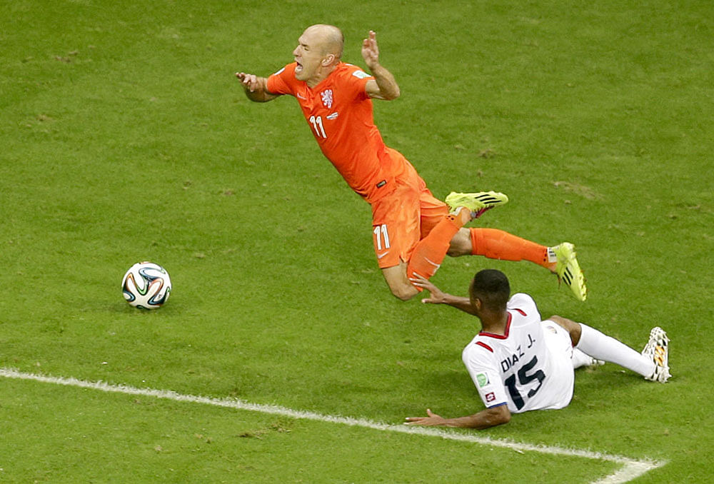 Netherlands' Arjen Robben, top, is fouled by Costa Rica's Junior Diaz during the World Cup quarterfinal soccer match between the Netherlands and Costa Rica at the Arena Fonte Nova in Salvador, Brazil, Saturday, July 5, 2014.