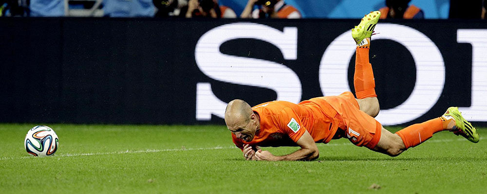 Netherlands' Arjen Robben falls after being fouled during the World Cup quarterfinal soccer match between the Netherlands and Costa Rica at the Arena Fonte Nova in Salvador, Brazil, Saturday, July 5, 2014.