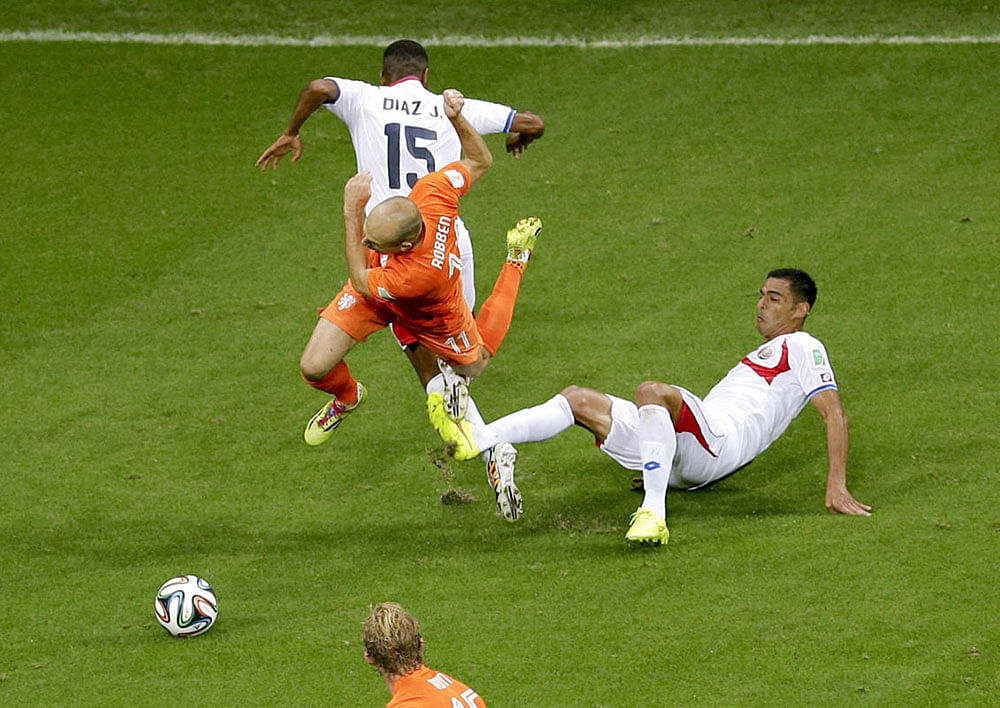 Netherlands' Arjen Robben is airborne after colliding with Costa Rica's Michael Umana during the World Cup quarterfinal soccer match between the Netherlands and Costa Rica at the Arena Fonte Nova in Salvador, Brazil, Saturday, July 5, 2014.