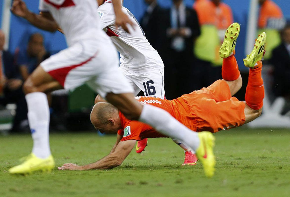 Arjen Robben of the Netherlands is fouled by Costa Rica's Cristian Gamboa during their 2014 World Cup quarter-finals at the Fonte Nova arena in Salvador July 5, 2014.