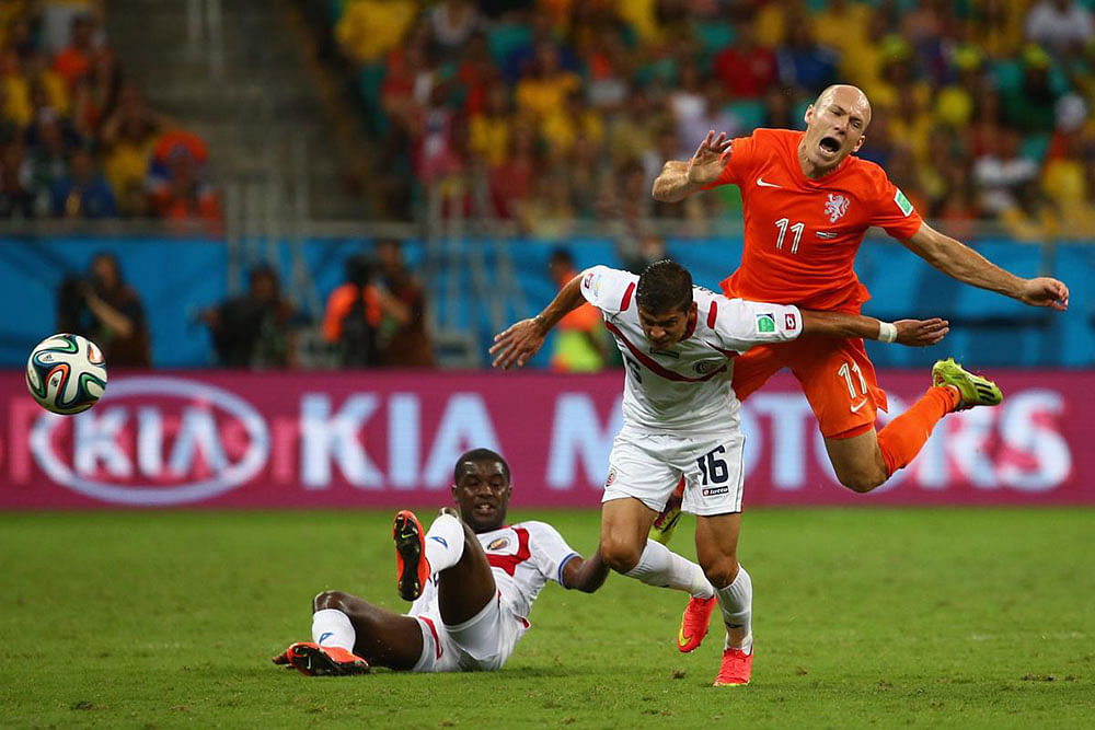 Cristian Gamboa of Costa Rica challenges Arjen Robben of the Netherlands during the 2014 FIFA World Cup Brazil Quarter Final match between the Netherlands and Costa Rica at Arena Fonte Nova on July 5, 2014 in Salvador, Brazil.