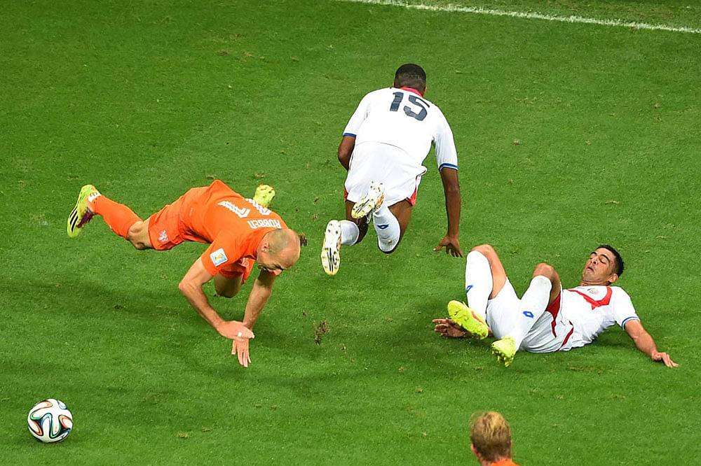 Arjen Robben of the Netherlands is challenged by Junior Diaz (L) and Michael Umana of Costa Rica resulting in a yellow card for Umana during the 2014 FIFA World Cup Brazil Quarter Final match between the Netherlands and Costa Rica at Arena Fonte Nova on July 5, 2014 in Salvador, Brazil.