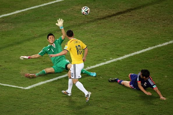 James Rodriguez of Colombia shoots and scores his team's fourth goal past goalkeeper Eiji Kawashima of Japan during the 2014 FIFA World Cup Brazil Group C match between Japan and Colombia at Arena Pantanal on June 24, 2014 in Cuiaba, Brazil. Photo: Getty Images