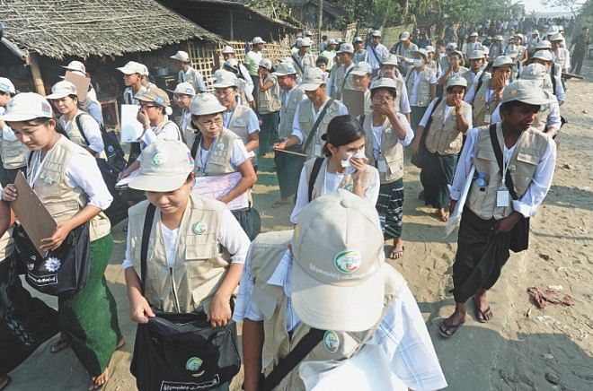 Census enumerators leave visiting the village of Barasa of Rakhine state. Myanmar has said that Muslims would not be allowed to register as Rohingya in its first census in three decades. Photo: AFP. 