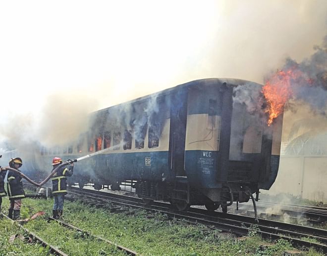 Firefighters try to control the blaze in Kalni Express, a train heading for Dhaka from Sylhet, at Cantonment Railway Station in the capital yesterday. Photo: Courtesy