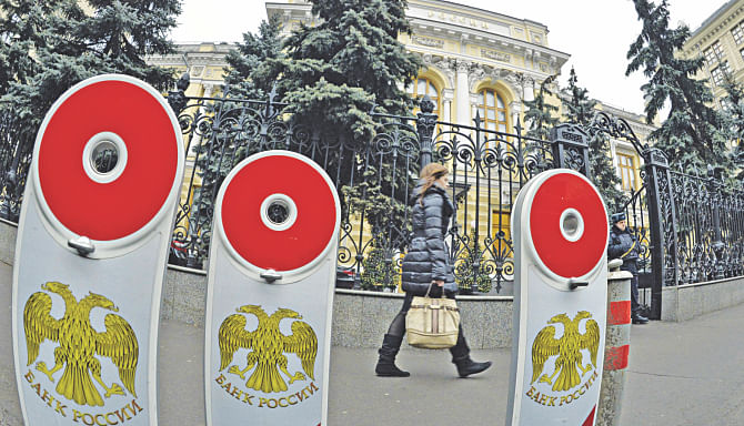 A woman walks past the head office of Russia's central bank in Moscow. Photo: AFP