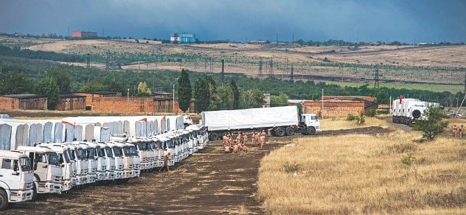 Lorries, part of a Russian humanitarian convoy, are parked not far from a checkpoint at the Ukrainian border some 30 km outside the town of Kamensk-Shakhtinsky in the Rostov region, yesterday. Tension between Moscow and Kiev is simmering over Russia's decision to try and deliver what it claims to be a huge humanitarian aid convoy that the Ukrainian authorities fear may be used to smuggle in arms to the pro-Kremlin insurgents. Photo: AFP