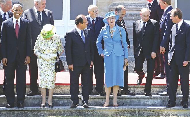 Russian President Vladimir Putin (3rd R) arrives for a group photo for the 70th anniversary of the D-Day landings at Benouville Castle, June 6, 2014. World leaders and veterans gathered by the beaches of Normandy to mark the 70th anniversary of the Allied landings in Normandy on D-Day during World War II. Also pictured are (L-R) US President Barack Obama, Britain's Queen Elizabeth, French President Francois Hollande, Denmark's Queen Margrethe II and Luxembourg's Grand Duke Henri. Obama and Putin held informal talks yesterday, diplomatic sources said, amid the worst crisis in ties between the United States and Russia in decades over the unrest in Ukraine. Photo: AFP