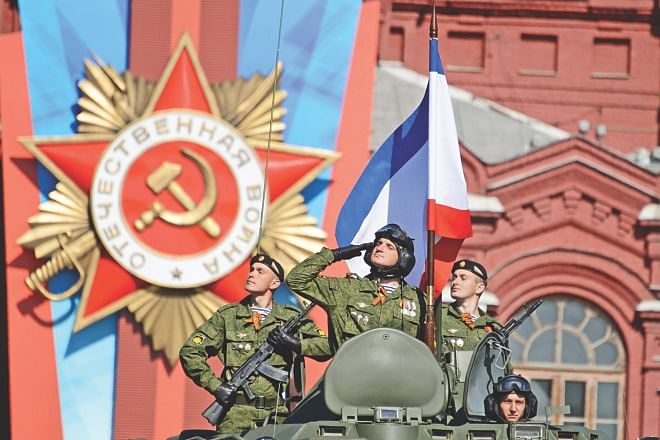 Russian soldiers salute Vladimir Putin and Prime Minister Dmitry Medvedev during a Victory Day parade at the Red Square in Moscow, yesterday.  Photo: AFP