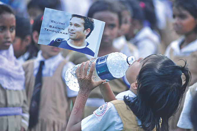 It was a long wait for this girl to catch a glimpse of Sachin. 5. The honorary Indian Air Force group captain waves to photographers from the cockpit of a chopper. PHOTO: FIROZ AHMED