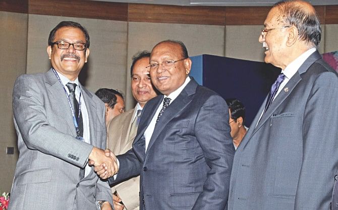 Saiful Islam, managing director of Picard Bangladesh, receives a CIP card for 2012 from Commerce Minister Tofail Ahmed at a function at Radisson Hotel in Dhaka yesterday. Islam received the award in leather and leather goods export category. Photo: Star