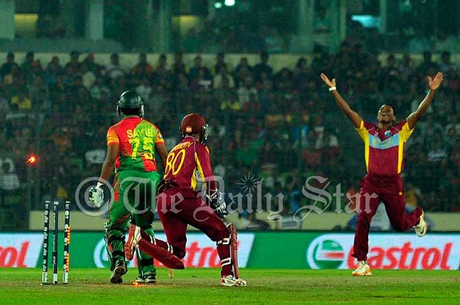 Krishmar Santokie cheers his second wicket on a row as he picked up Bangladesh batsman Shakib Al Hasan during a World T20 match today at Mirpur: Photo: Firoz Ahmed
