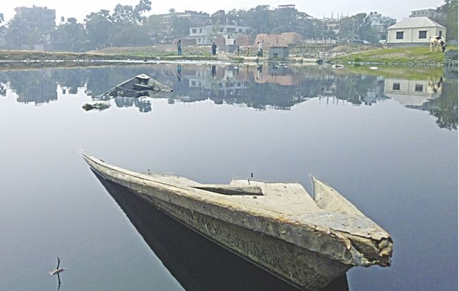 What was once a canal bubbling with life and bringing prosperity to communities in Savar is now a mass of mud, algae and garbage peering over murky waters with only a broken boat to signify its history. Photo: Rashad Ahamad 