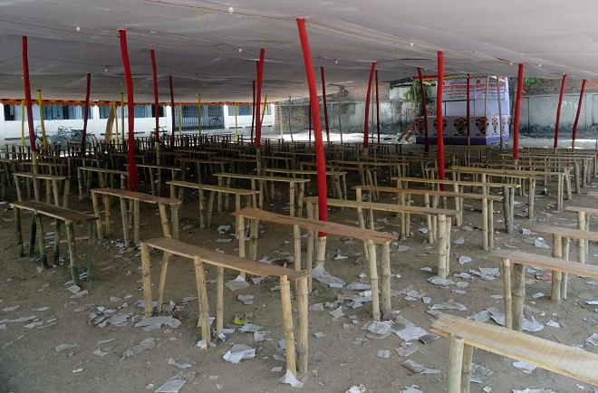 Seating arrangements covered by a large canopy occupy the playground of Dhukurjhari High School in Biral upazila under Dinajpur district as unscrupulous people are organising obscene dances and gambling in the name of a month-long fair there. PHOTO: STAR