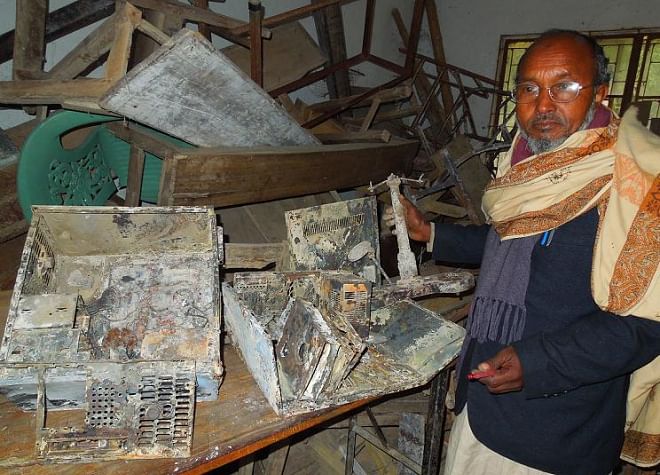 Azizul Islam, retired headmaster of the school, shows valuables including furniture, computers and multimedia equipment destroyed in the barbaric act. PHOTO: STAR