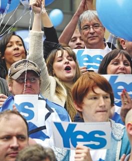 Pro-independence supporters chant slogans and hold ‘Yes’ signs during a rally in central Glasgow, Scotland.  Photo: AFP