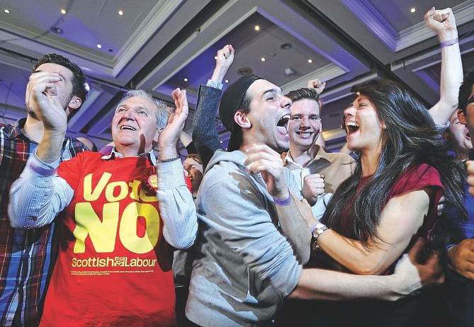 Pro-union supporters celebrate after Scottish independence referendum results are announced in Glasgow yesterday. Photo: AFP