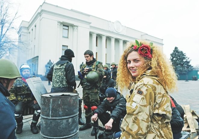 Maidan self-defence activists guard at the Ukraine parliament during the session in Kiev. While Ukraine's opposition-dominated parliament yesterday delayed the highly-anticipated formation of a new government until tomorrow, it voted to apply to the International Criminal Court to prosecute Yanukovych over the 