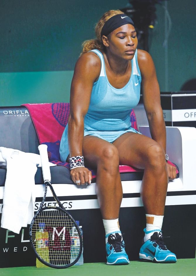 A dejected Serena Williams rests during the WTA Finals against Simona Halep in Singapore yesterday. Serena suffered her worst loss in 16 years.  PHOTO: AFP