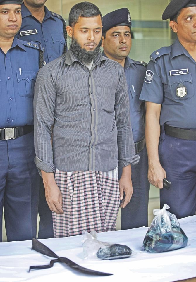 Shah Alam arrested for murdering madrasa boy Abu Raihan in Keraniganj on Monday produced before the media at the media centre of Dhaka Metropolitan Police yesterday. photo: star