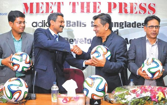 FIFA development officer Shaji Prabhakaran (2nd from L) hands over FIFA Adidas footballs to BFF president Kazi Salahuddin (2nd from R) during a press conference at the BFF House yesterday. PHOTO: COURTESY