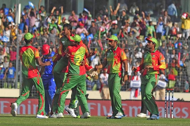 Bangladesh's ace all-rounder Shakib Al Hasan is the toast of his teammates after taking one of his three wickets which restricted Afghanistan to 72 in the opening fixture of the World T20 at the Sher-e-Bangla National Stadium in Mirpur yesterday. PHOTO: firoz ahmed