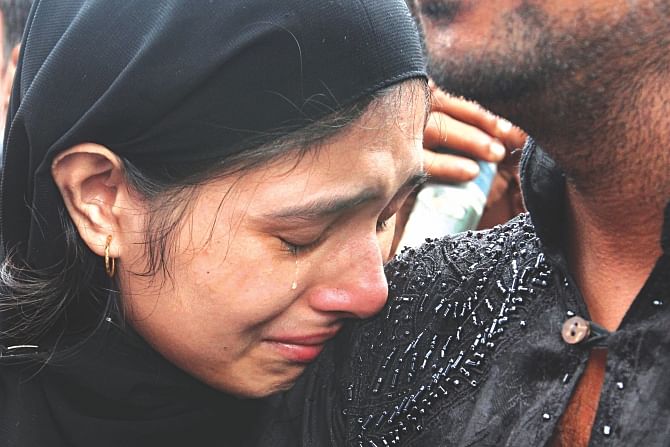 Labony Akhter shedding tears on her uncle Shahidul Islam's shoulder at Mawa ferry terminal yesterday. She lost three members of her family -- her sister Rozina Akhter, aunt Ayesha Akhter, and cousin Sara Islam -- when Pinak-6 went down. The uncle in the picture had managed to swim ashore. Photo: Anisur Rahman