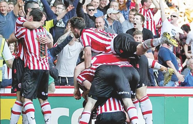 Sheffield United players erupt in joy after a goal which secured their place into the semifinals of the FA Cup yesterday at Bramall Lane, Sheffield. Photo: Internet