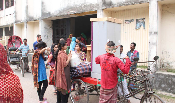 Female students of Sher-e-Bangla Medical College in Barisal start leaving their five-storey dormitory on the campus yesterday as the authorities closed the institution for three weeks after the dorm became risky with some portions of plaster from a pillar and the wall, falling down inside the building following construction of another five-storey dormitory too close to it. Photo: Arifur Rahman