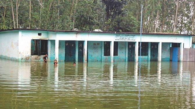 Shimulbari Government Primary School in Dhunat upazila of Bogra has been declared closed as it is partially submerged in water after the river Jamuna flooded, leaving the fates of the students' education uncertain. Photo: Star