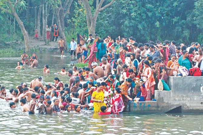 Hindu devotees take a holy dip in the Ganges at Shombolpur Ghat of Nemayetpur village in Pabna. Photo: Star
