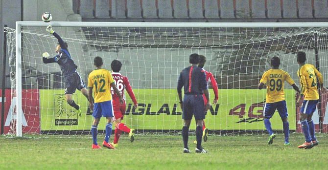 Busan I'Park goalkeeper Lee Chang Gyun kept his side from conceding with a few saves like this one during their international friendly against Sheikh Jamal Dhanmondi Club at the Bangabandhu National Stadium yesterday. PHOTO: STAR