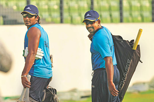 Sri Lanka players Kusal Perera (L) and Rangana Herath leave the Sher-e-Bangla National Stadium for the nearby indoor facility for some batting practice while West Indies captain Darren Sammy does some stretching at the National Cricket Academy ground yesterday. Photo: Star