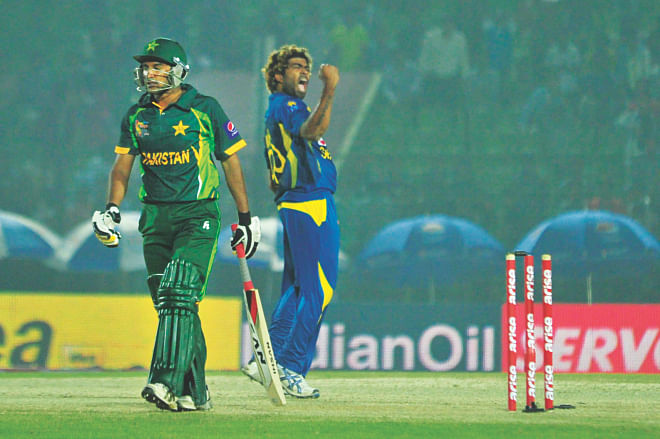 Sri Lanka paceman Lasith Malinga (R) pumps his fist after dismissing Pakistan batsman Bilawal Bhatti to lead his side to a 12-run win in the opening match of the Asia Cup at the Fatullah Stadium yesterday. PHOTO: FIROZE AHMED