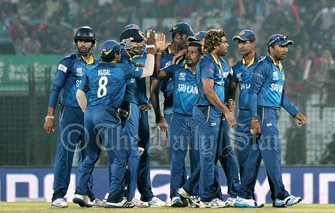 Sri Lankan players cheer another Kiwi wicket during the 'quarterfinal' of the World T20 at Chittagong on Monday evening. Photo: Anurup Kanti Das