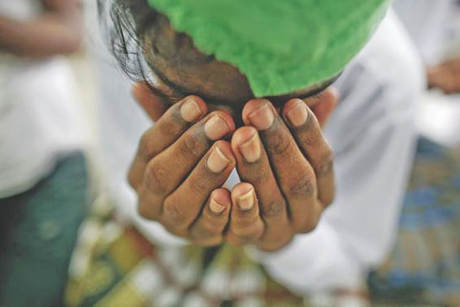 A victim of human trafficking prays at a government shelter in Takua Pa district of Phang Nga in Thailand. Photo: Reuters