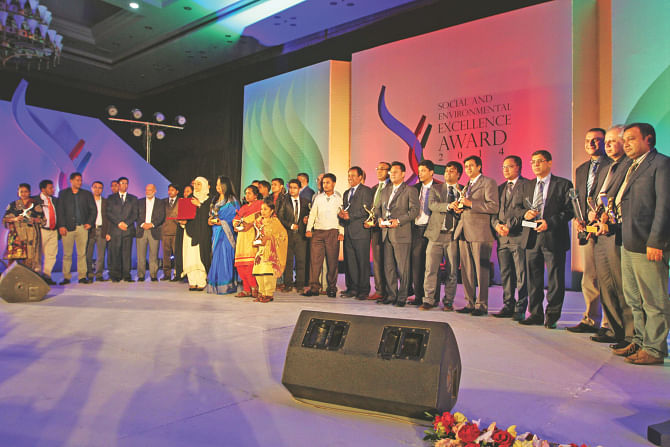 Winners of Social and Environmental Excellence Award pose at the closing ceremony of the three-day Apparel Summit at Bangabandhu International Conference Centre in Dhaka on Tuesday. Photo: Star