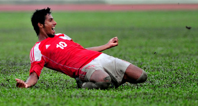Keep Smiling: Bangladesh U-23 midfielder Sohel Rana slides on the greens of Army Stadium after his winning goal against Nepal U-23 on August 26. Photos: Star File