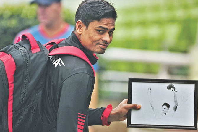 PICTURE WITHIN A PICTURE: Spinner Taijul Islam has his hattrick moment framed. Photo: Star 