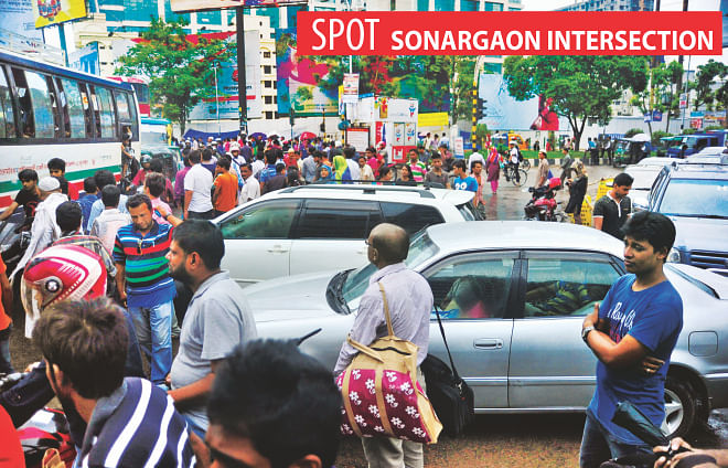 A large number of pedestrians, walking through the busy Sonargaon intersection in the capital, obstruct the normal flow of traffic. Though there is an underpass [not in the frame] nearby, these pedestrians carefully ignore it. The photo was taken around 4:30pm yesterday. Photo: Firoz Ahmed