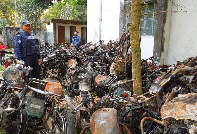 This file photo shows wreckage of 39 burnt motorbikes of the activists of Awami League and its front organisations, bearing testimony to the extent of barbaric attack on a December 14 march led by AL lawmaker Asaduzzaman Noor near Ramganj, eight km off Nilphamari town, is kept on the premises of Nilphamari Sadar Police Station