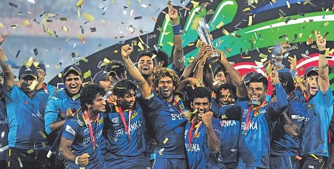 CLASS OF 2014: Members of the victorious Sri Lanka cricket team celebrate with the ICC World Twenty20 trophy at the Sher-e-Bangla National Stadium in Mirpur yesterday. The Lankans won the final against India by six wickets. Photo: FIROZ AHMED