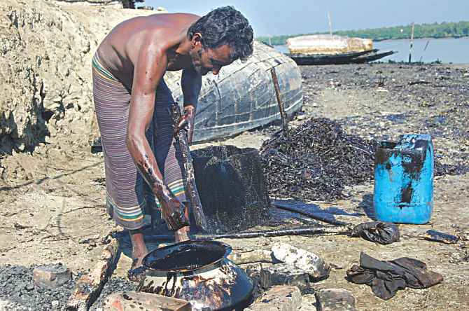 A local separates the layer of oil from a piece of wood. He then heats the sticky substance to make it lose density. Photo: Pinaki Roy 
