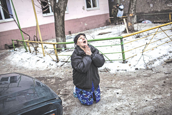 A Ukrainian woman begs Ukrainian President Petro Poroshenko to stop the bombing in Donetsk after shell hit the residential area where she lives, killing two civilians in Donetsk's Kyibishevsky district, yesterday. Photo: AFP