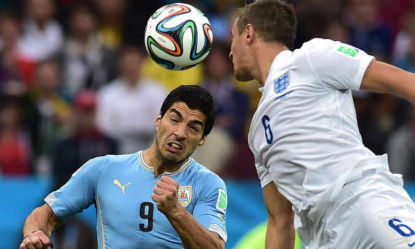 England's defender Phil Jagielka (R) heads the ball past Uruguay's forward Luis Suarez during the Group D football match between Uruguay and England at the Corinthians Arena in Sao Paulo on June 20, 2014, during the 2014 FIFA World Cup. Photo:Getty Images
