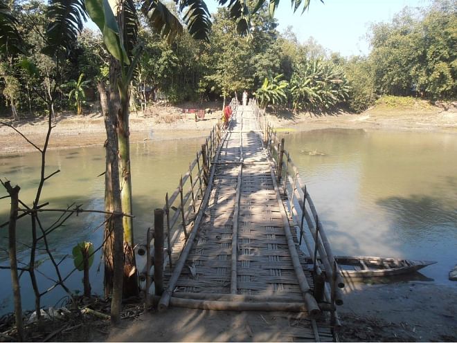 Overused and risky, this bamboo bridge over Phulkumar River in Royganj union of Nageshwari upazila under Kurigram district remains the lone means for walking across the river for thousands of people of several villages on the both sides of the river. PHOTO: STAR