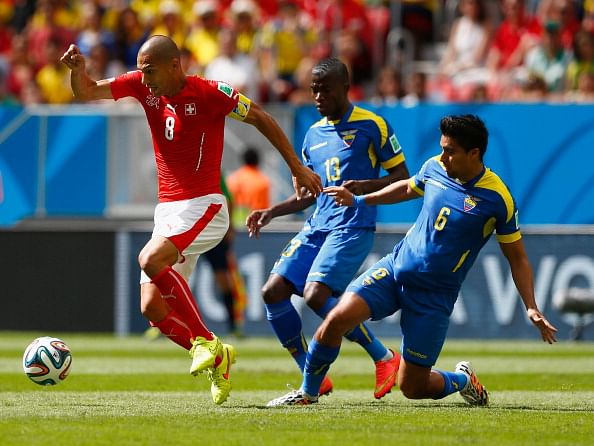 Gokhan Inler of Switzerland is challenged by Enner Valencia (C) and Christian Noboa of Ecuador during the 2014 FIFA World Cup Brazil Group E match between Switzerland and Ecuador at Estadio Nacional on June 15, 2014 in Brasilia, Brazil. Photo: Getty Images